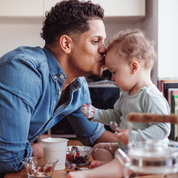 Man kissing baby's head