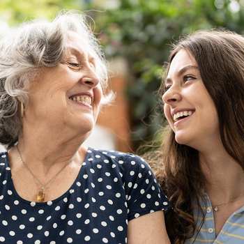 older woman laughing with younger woman