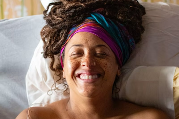smiling Black birthing person 