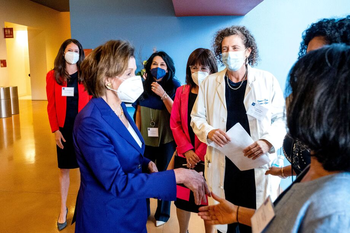 Nancy Pelosi greets fellow panelists at UCSF