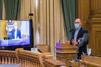 Larry Rand speaking at City Hall 